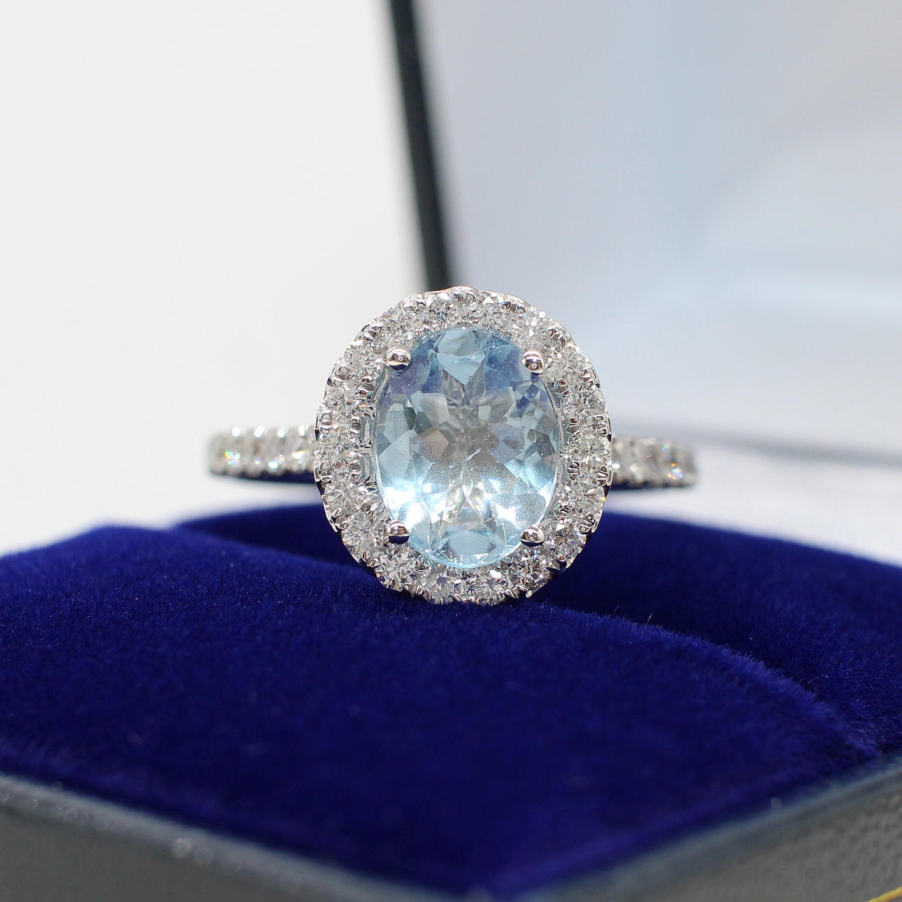 AQUAMARINE & DIAMOND HALO RING.
