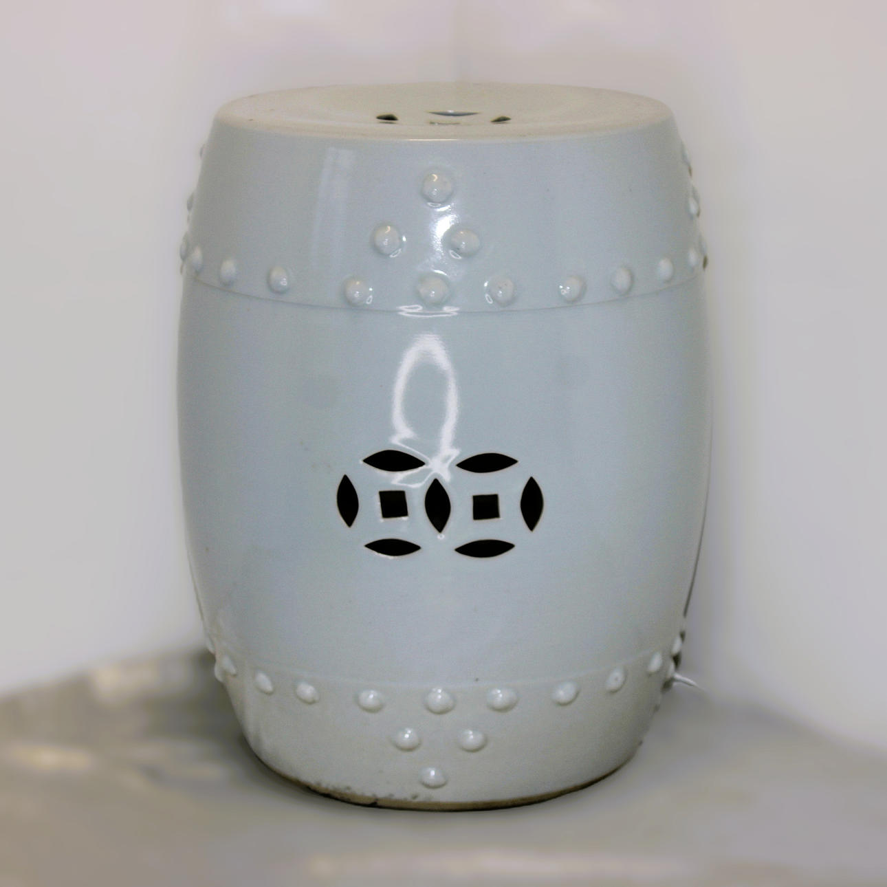 WHITE CERAMIC STOOL.