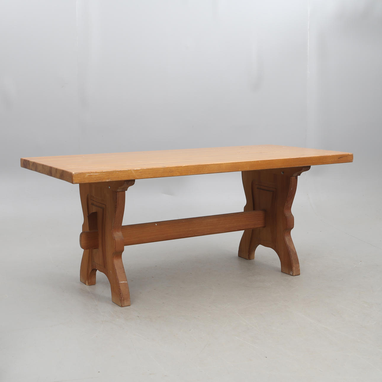 A wooden trestle table, 20th century.
