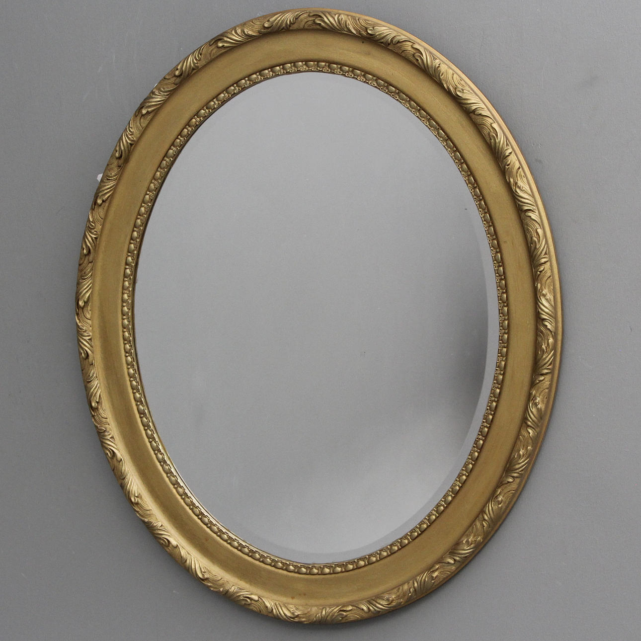 An oval mirror, 20th century.
