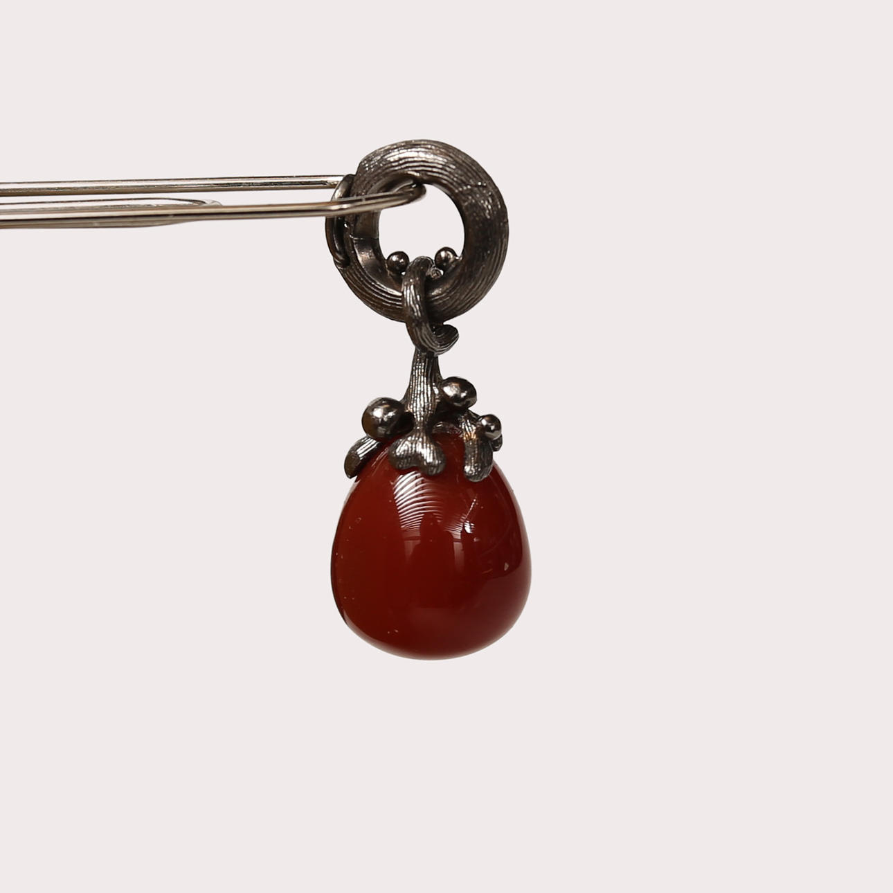 OLE LYNGGAARD. “Dew Drop”, oxidized silver, drop in carnelian.