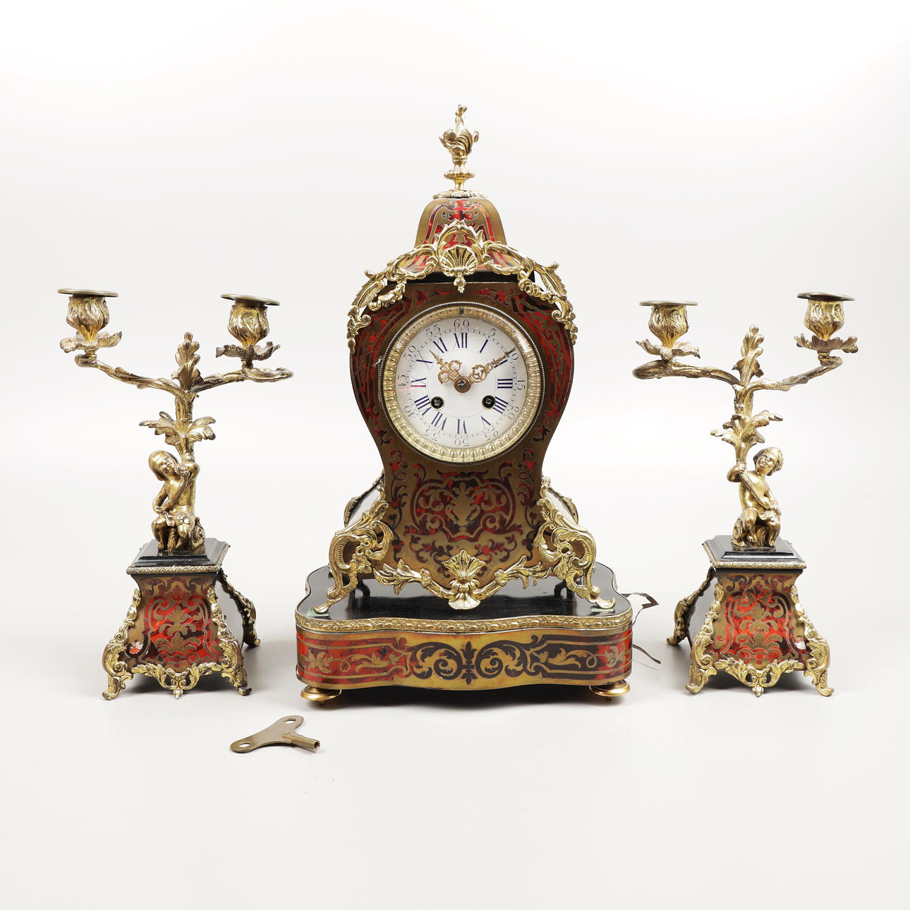 A four-piece French boulle candlestick table clock with candlesticks ...