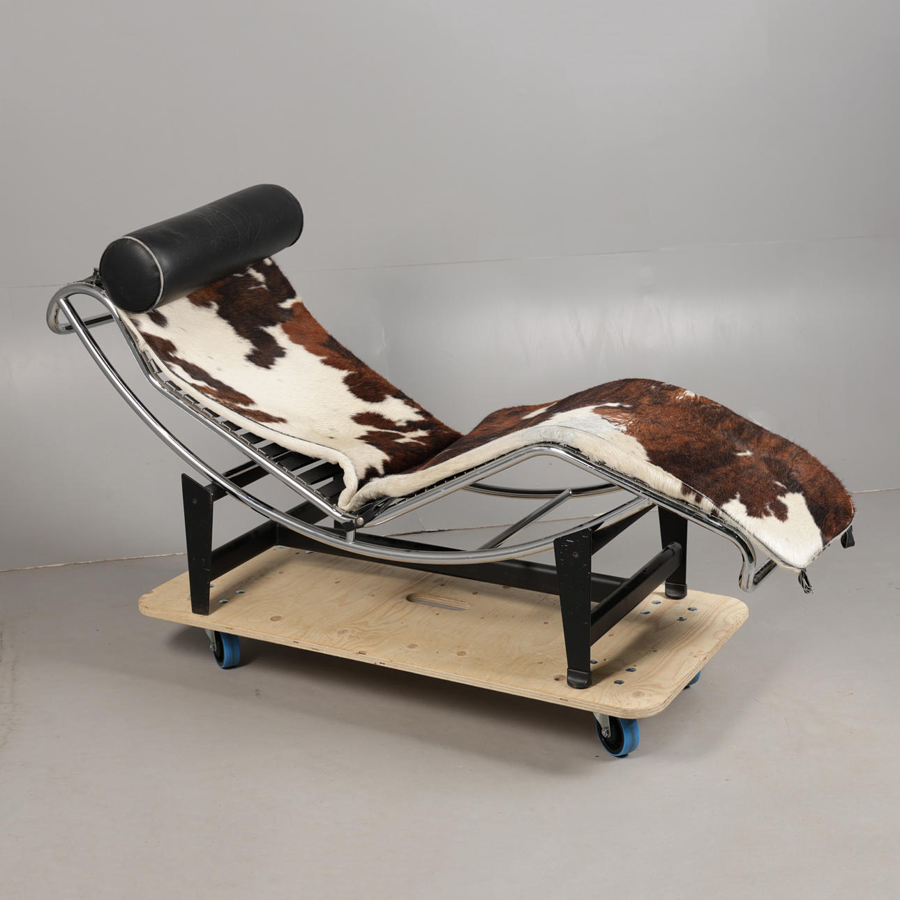 A COW HIDE LOUNGE CHAIR.