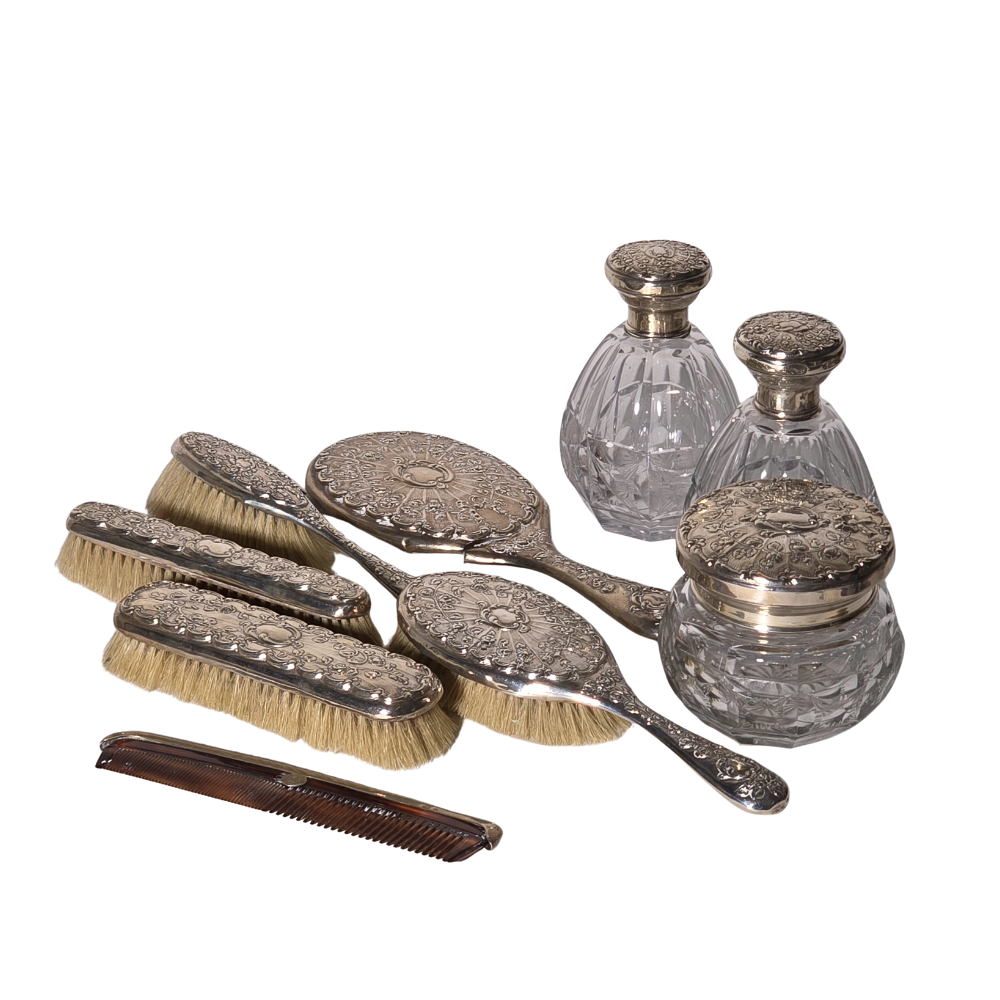 9-PIECE DRESSING TABLE SET IN PUNCHED SPANISH SILVER.