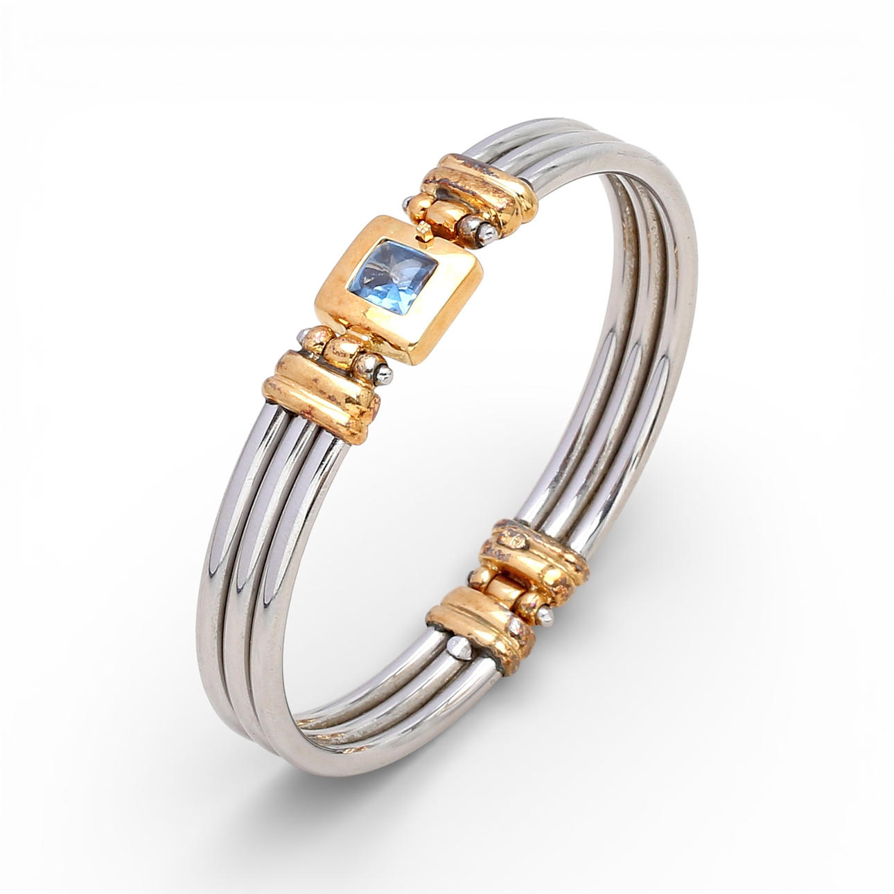 Two-tone gold bangle bracelet.