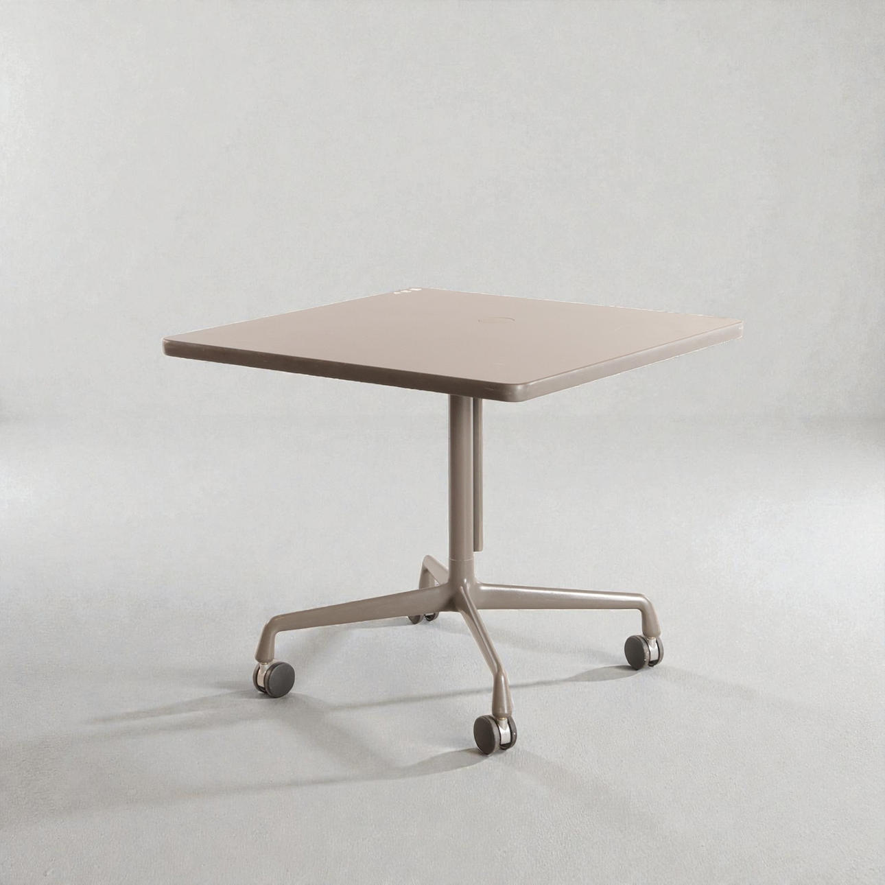 CHARLES & RAY EAMES. Vintage 'Segmented Table', table with column and square foot made of aluminum mounted with wheels, square light gray sheet of laminate, cable outlet/holder on plate. Designed in 1964. Manufactured and branded at Hermann Miller, USA.