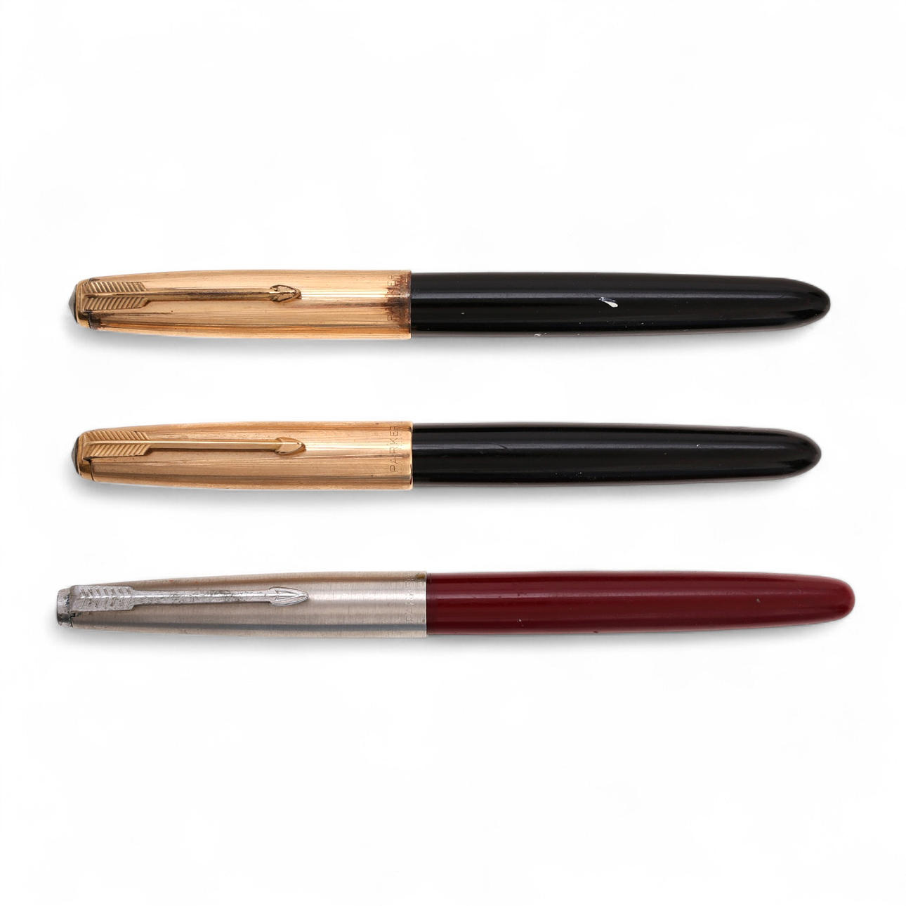 Three Parker fountain pens.