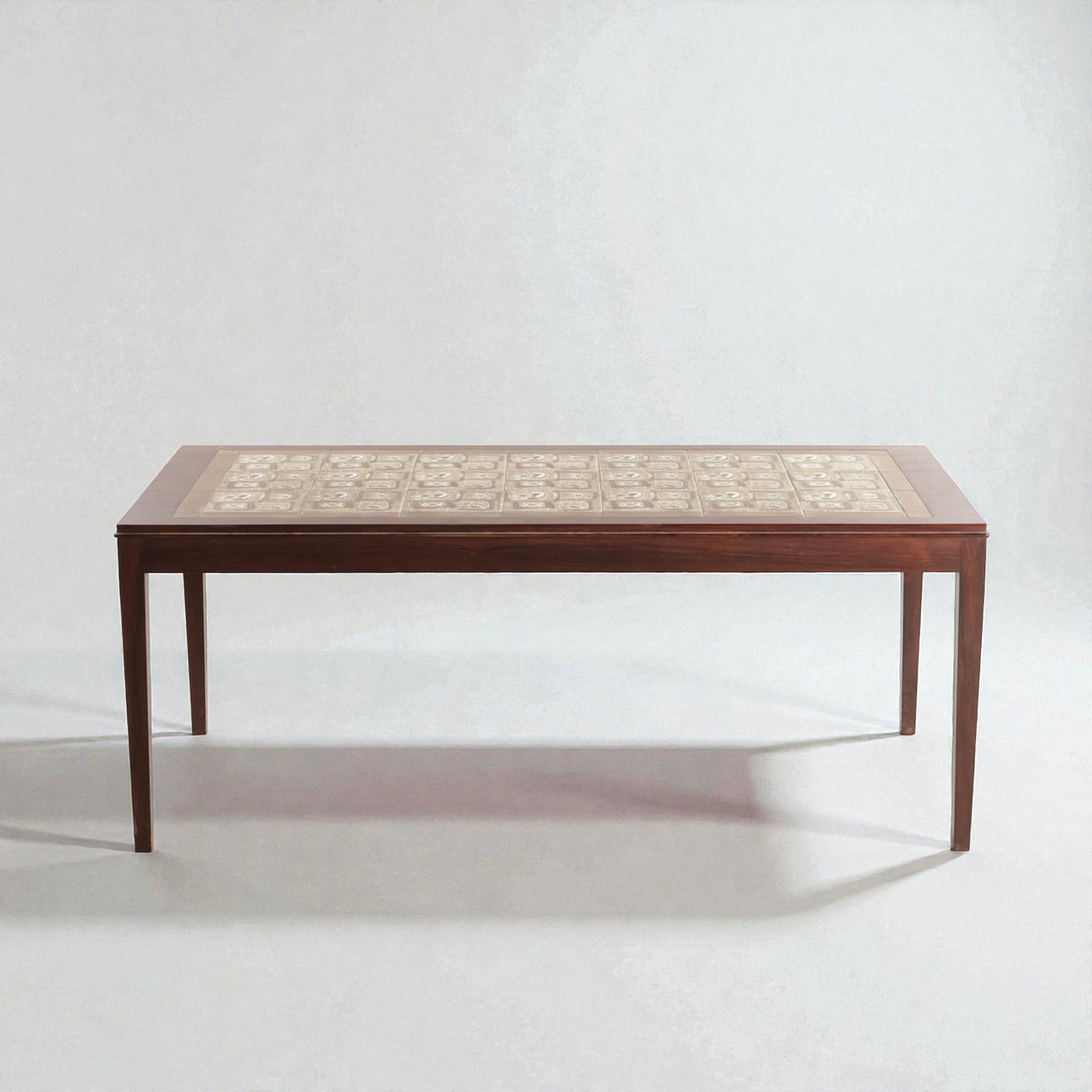 DANSK MØBELDESIGN. Rectangular rosewood coffee table with profiled frame, plate with glazed faience clinker from Royal Copenhagen. Denmark, 1960s.