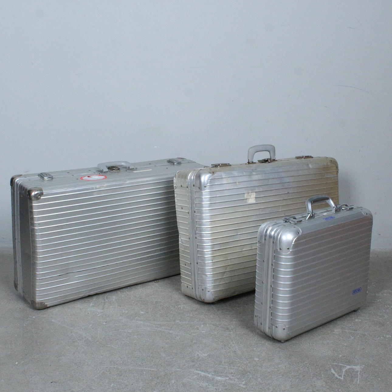 Three aluminum cases and a Rimowa.