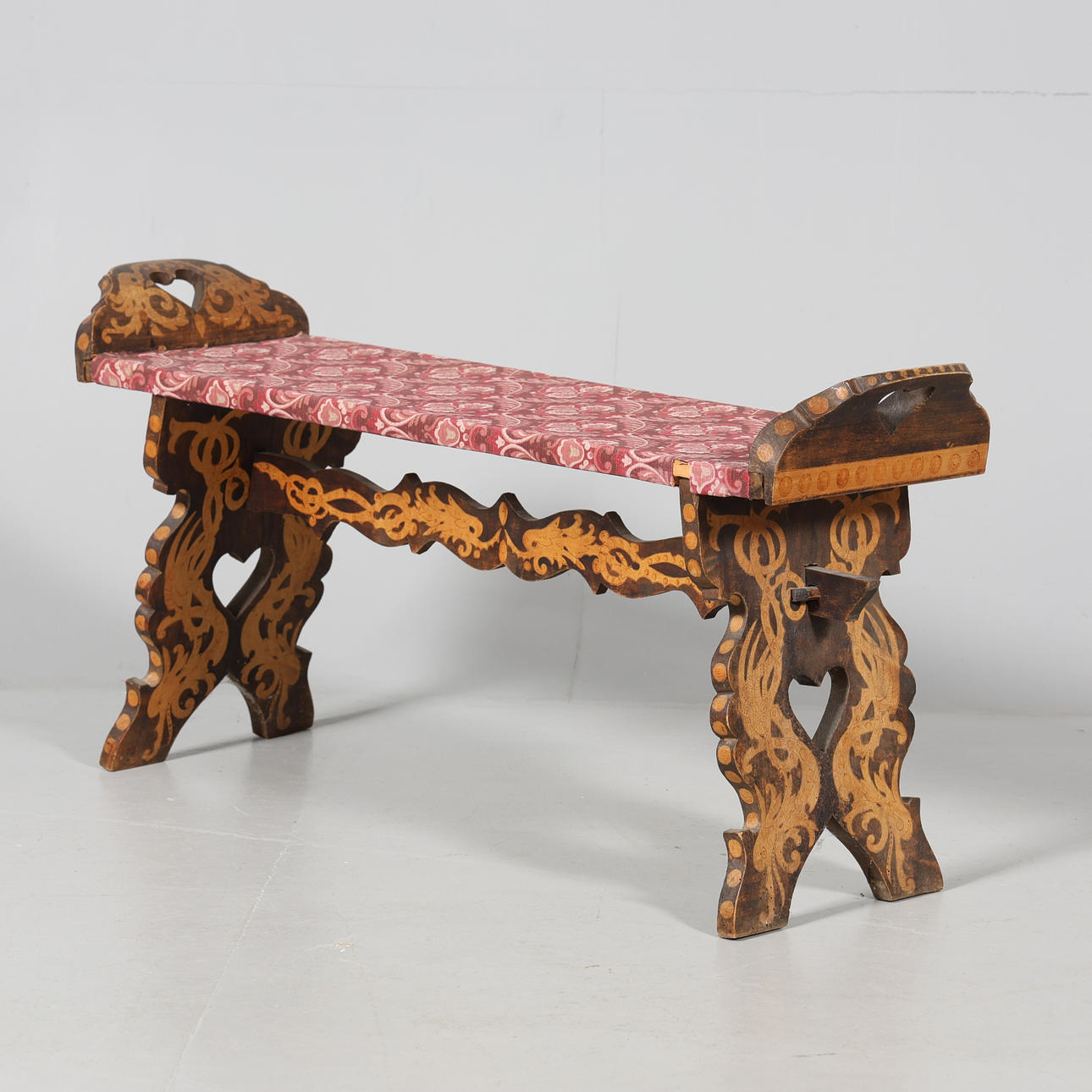 A 20th century intarsia bench.