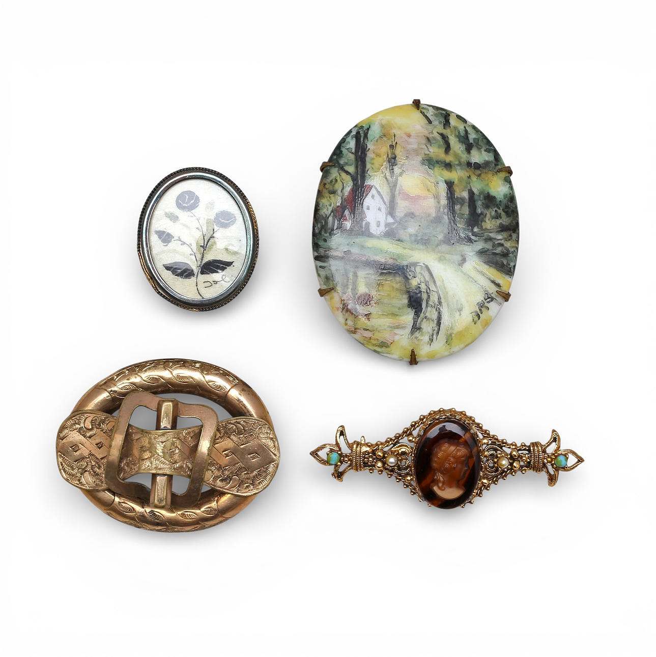 Four vintage brooches.