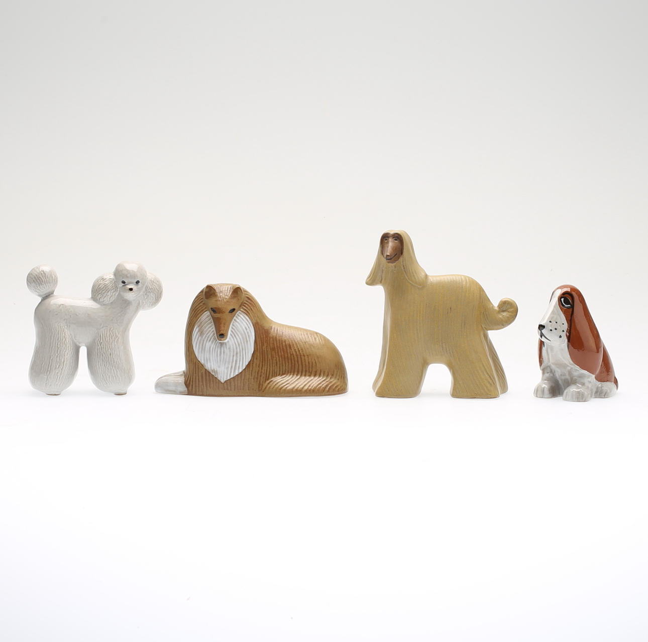 LISA LARSON. 4 st, stengods, figurer, "Collie", "Pudel", Basset" och "Afghan", hundkollektinen Vov, exklusivt för Åhléns Stengods.