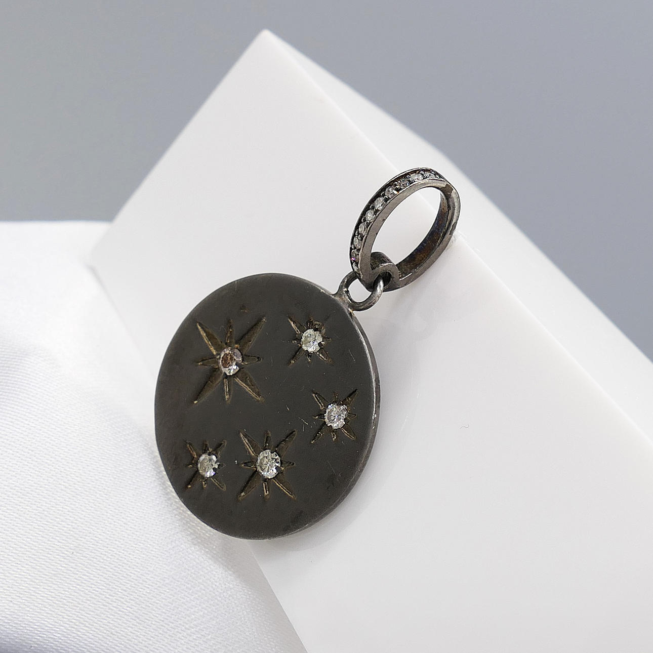 DIAMOND-SET disc pendant.
