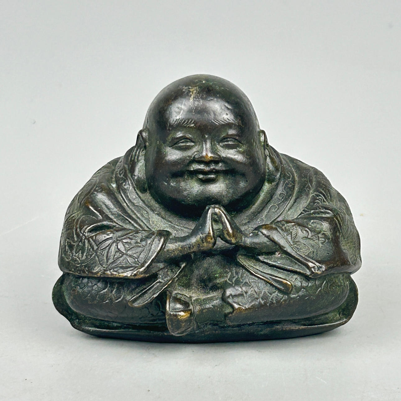 BRONZE PRAYING PUTAI FIGURE.