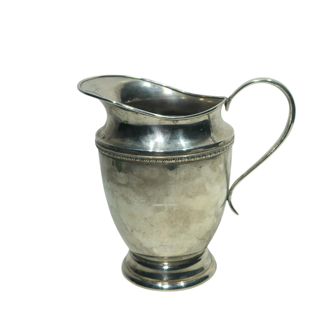 Large silver alpaca jug with decorated trim.