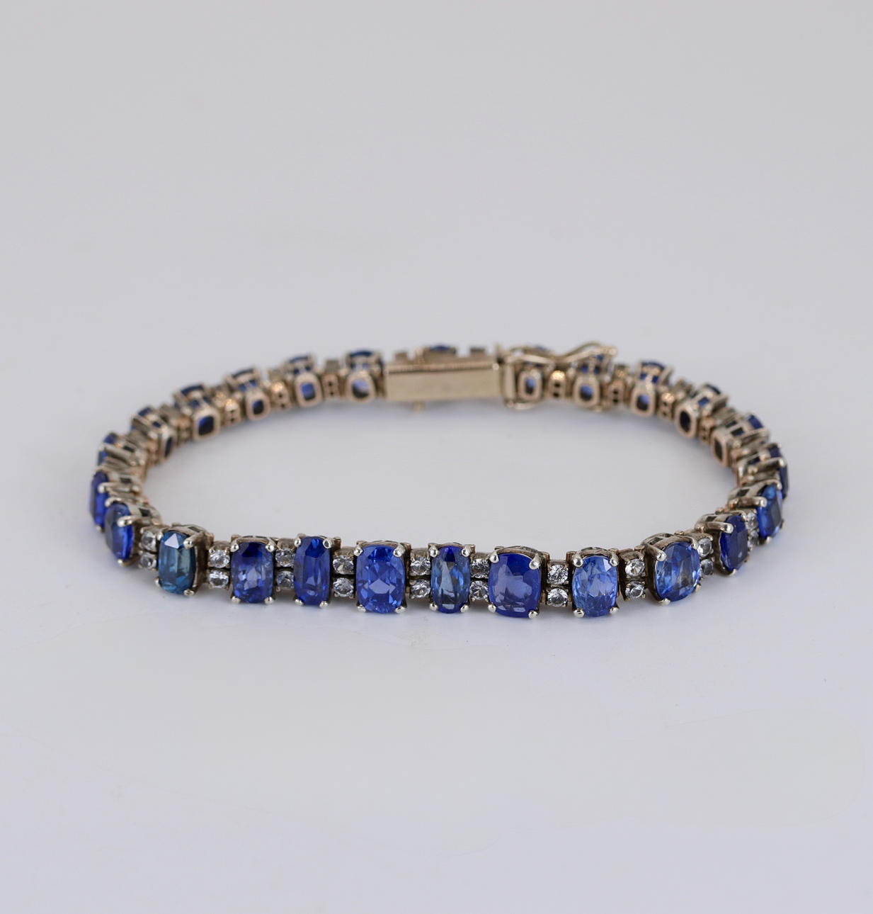 9CT GOLD/ SILVER SAPPHIRE SET BRACELET.