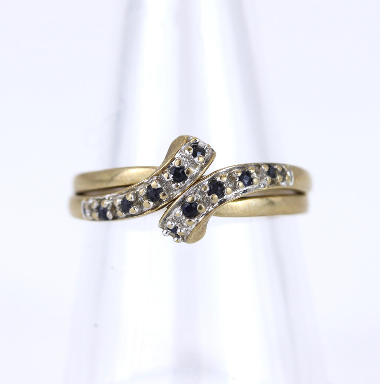 TWO INTERLOCKING 9CT GOLD RINGS.