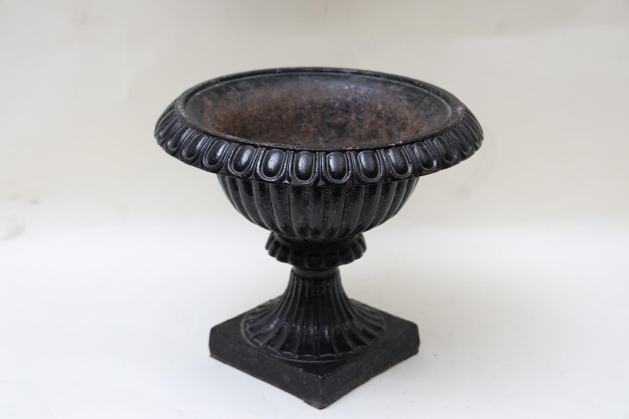 A 20th-century cast iron urn.