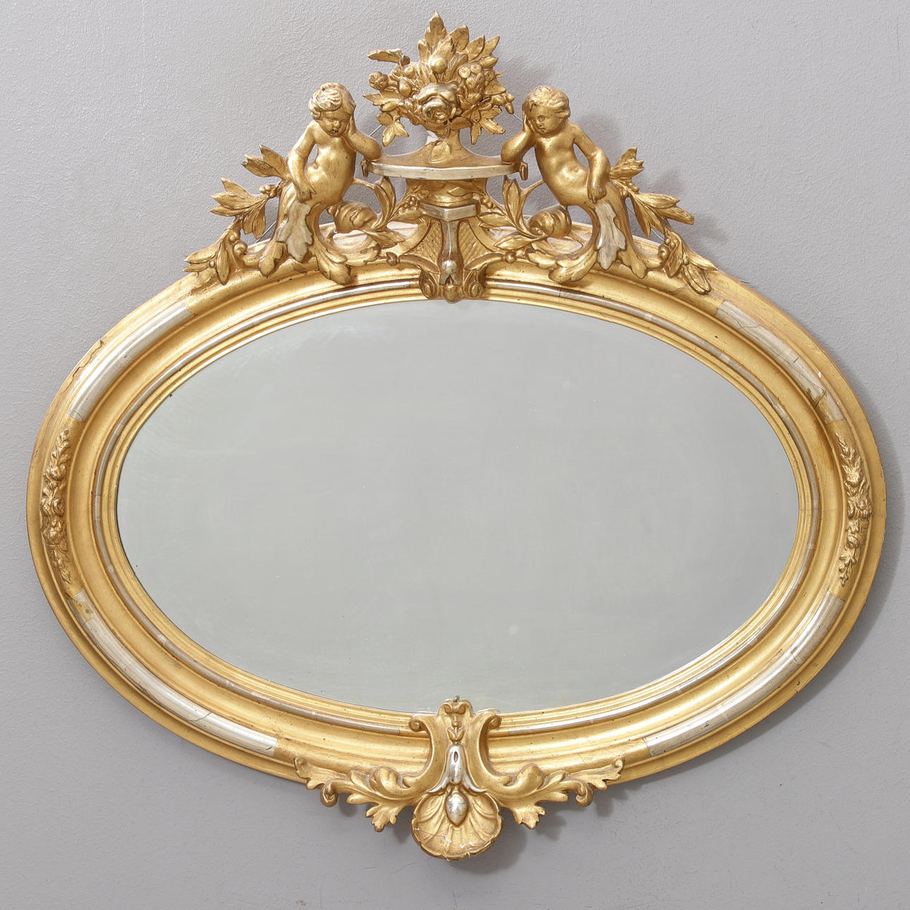 A partly gilded mirror, 19th century.