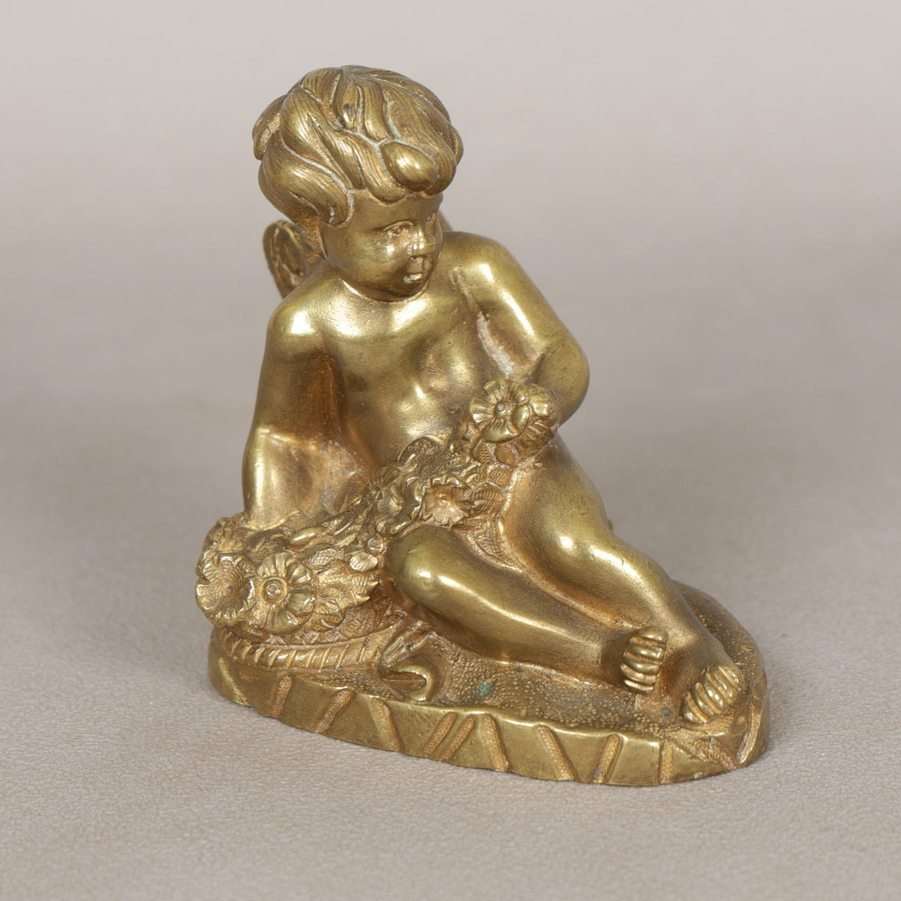A 19TH CENTURY GILT BRONZE PUTTO.