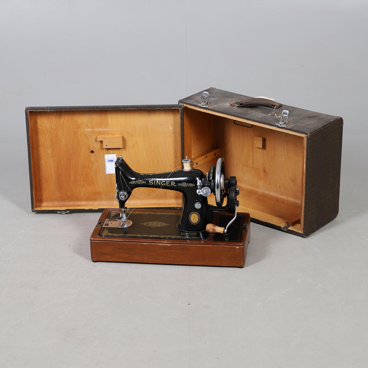 A SINGER MANUAL SEWING MACHINE.