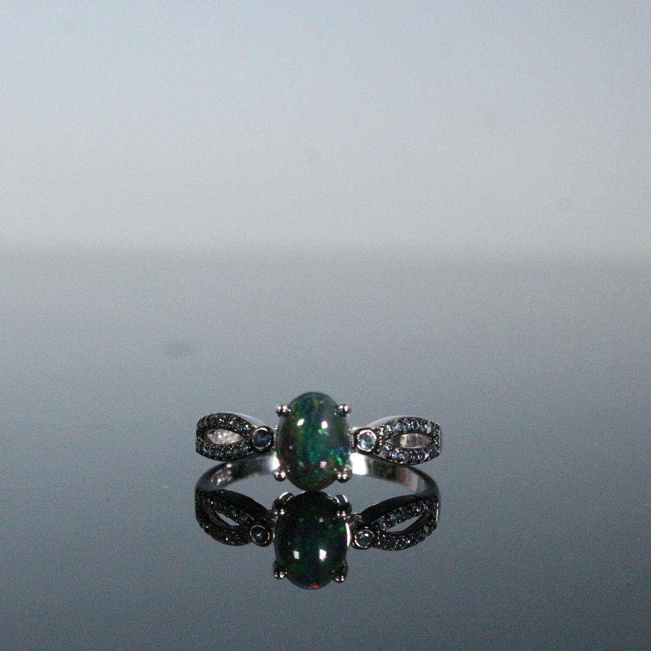 Ring with black opal and sapphire.