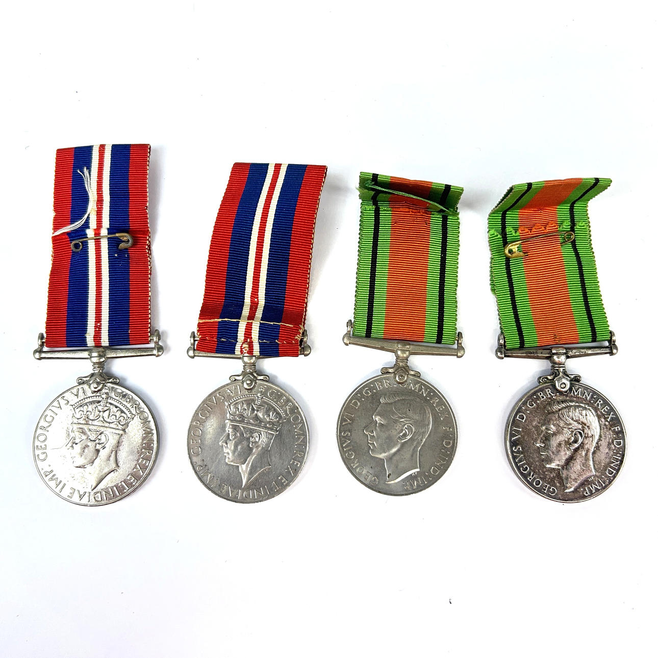A GROUP OF FOUR MEDALS.