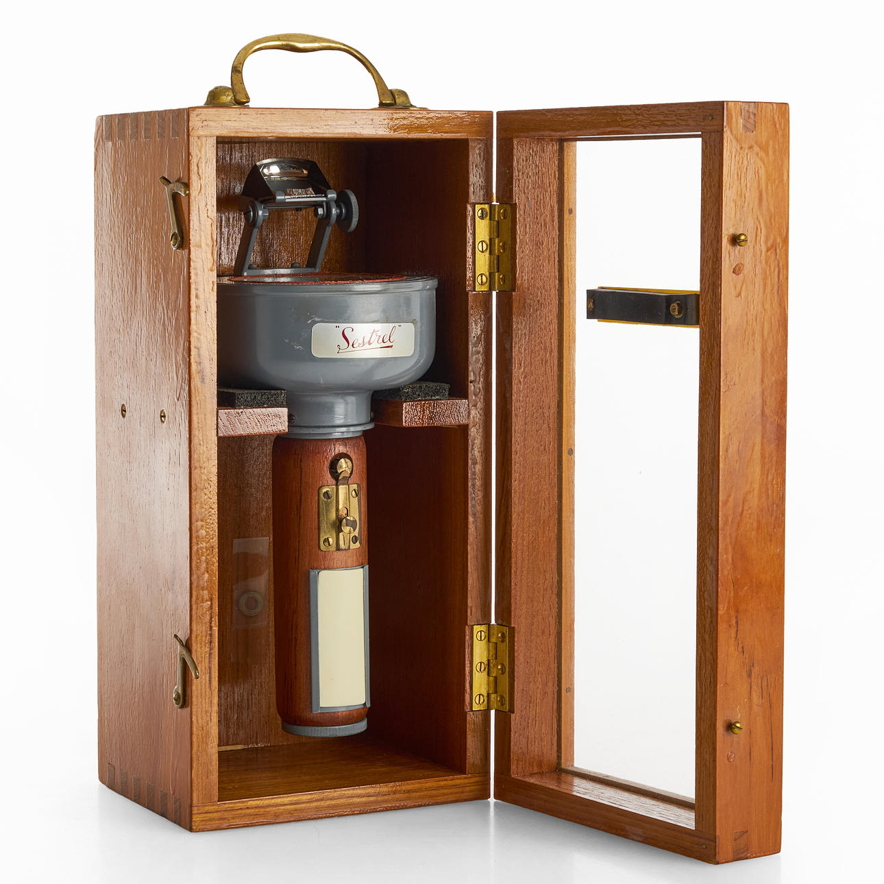 A hand-held compass, “Sestrel”, with sight prism, wall mounted storage case, Henry Browne & Son Ltd., England, circling the second quarter of the 20th century.