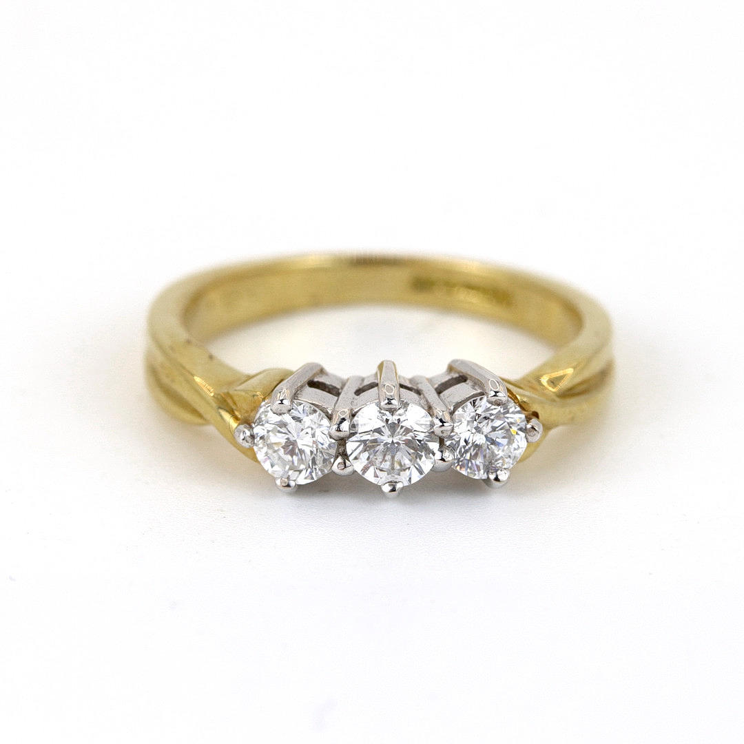 18K WHITE & YELLOW GOLD THREE DIAMOND SET RING.