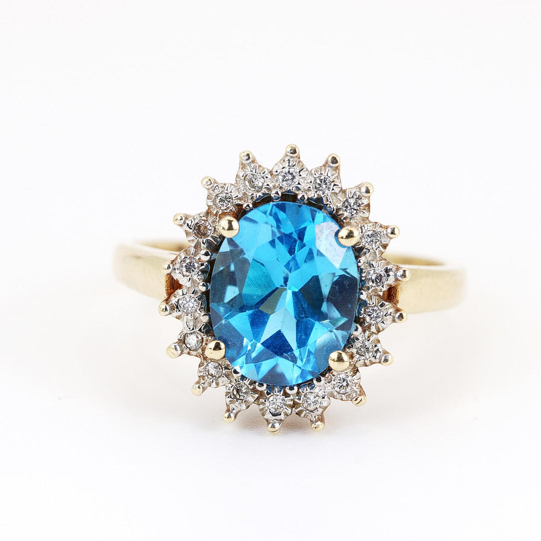 14K GOLD BLUE TOPAZ & DIAMOND SET RING.