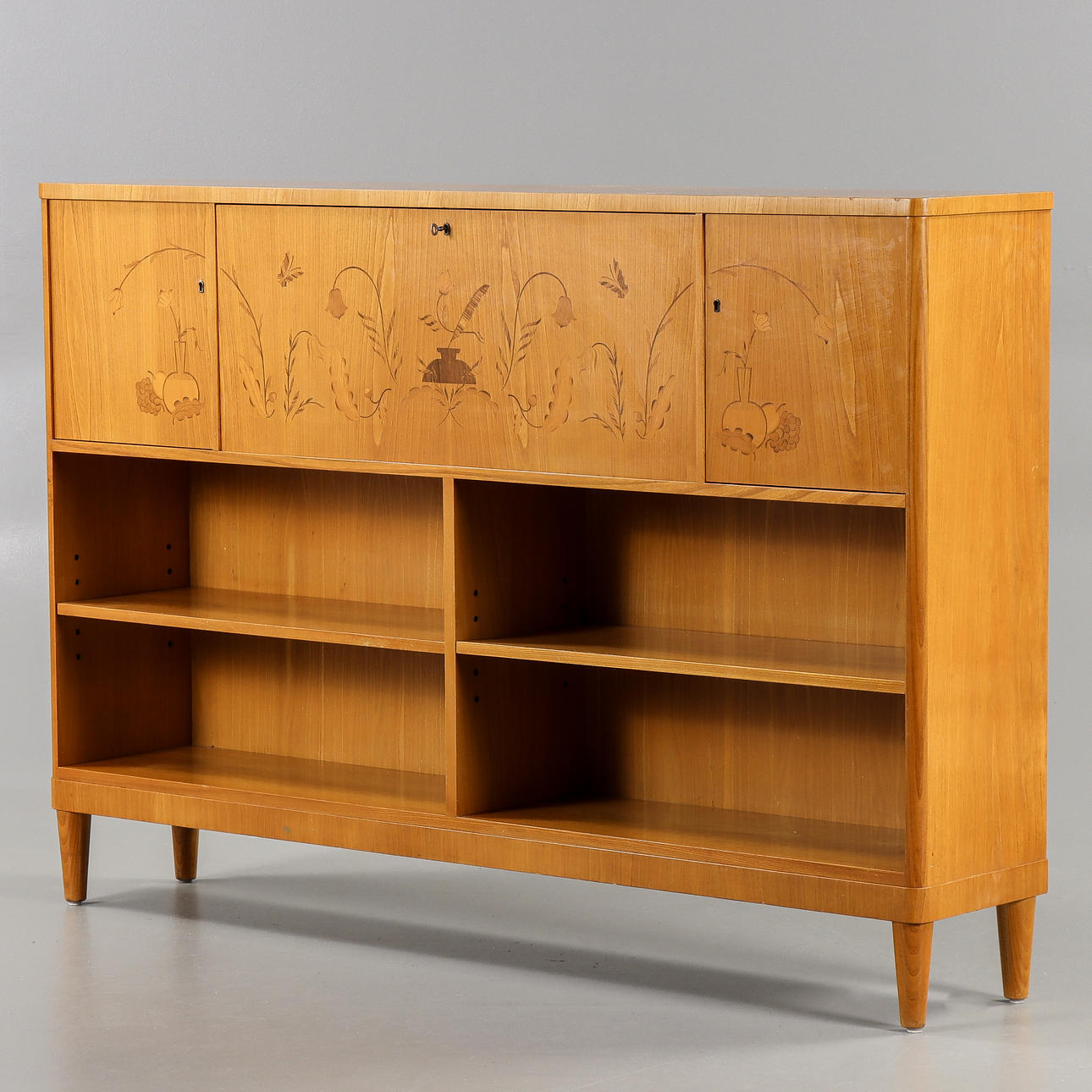 BOOKCASE With cabinet and drawer interior, 1940s.