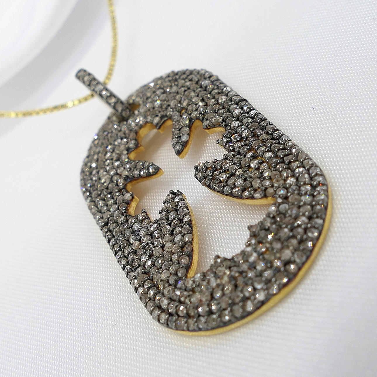 DIAMOND ENCRUSTED cross necklace.