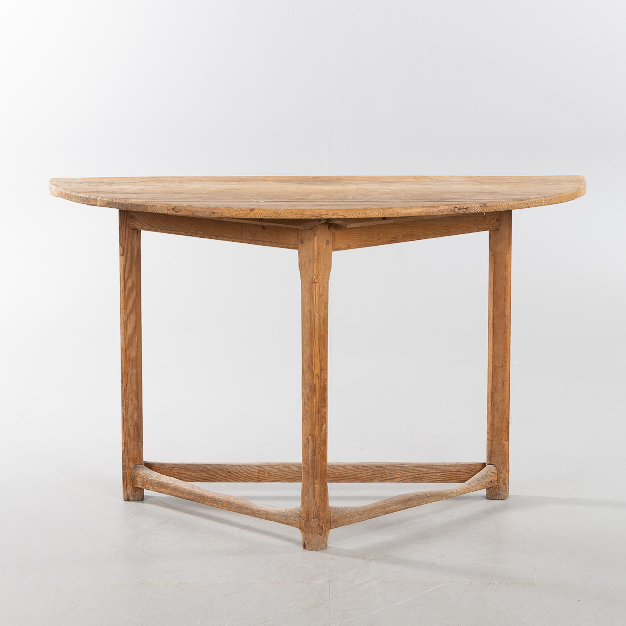 A 19th century pine crescent-shaped table.