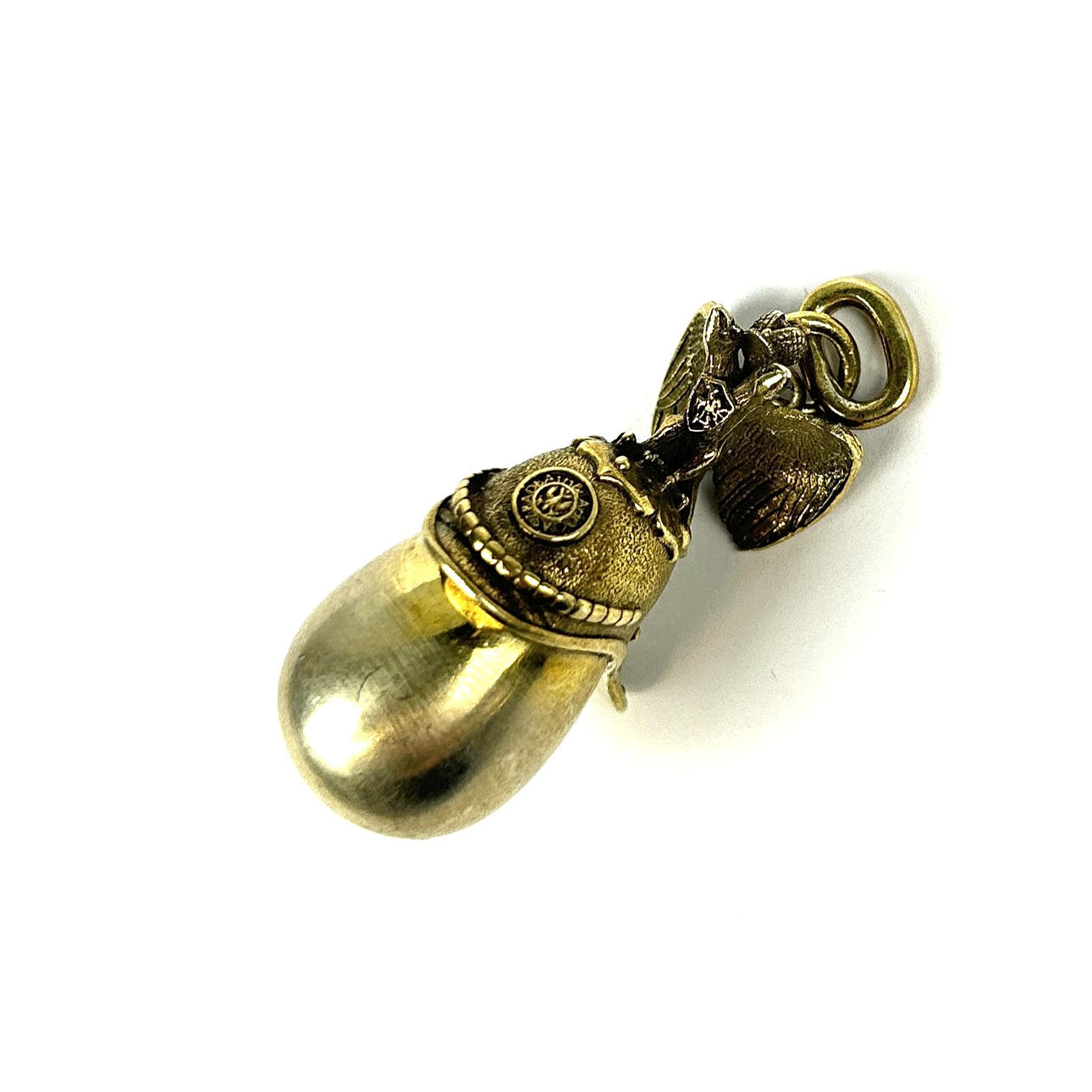 SILVER AND SILVER GILT EAGLE HELMET AND EGG PENDANT.