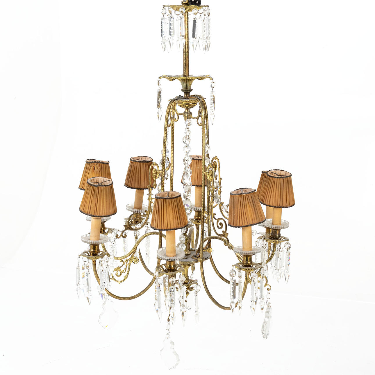 A CEILING CHANDELIER, Oscarian, brass frame, different cut prisms, electrified, 8 light points.