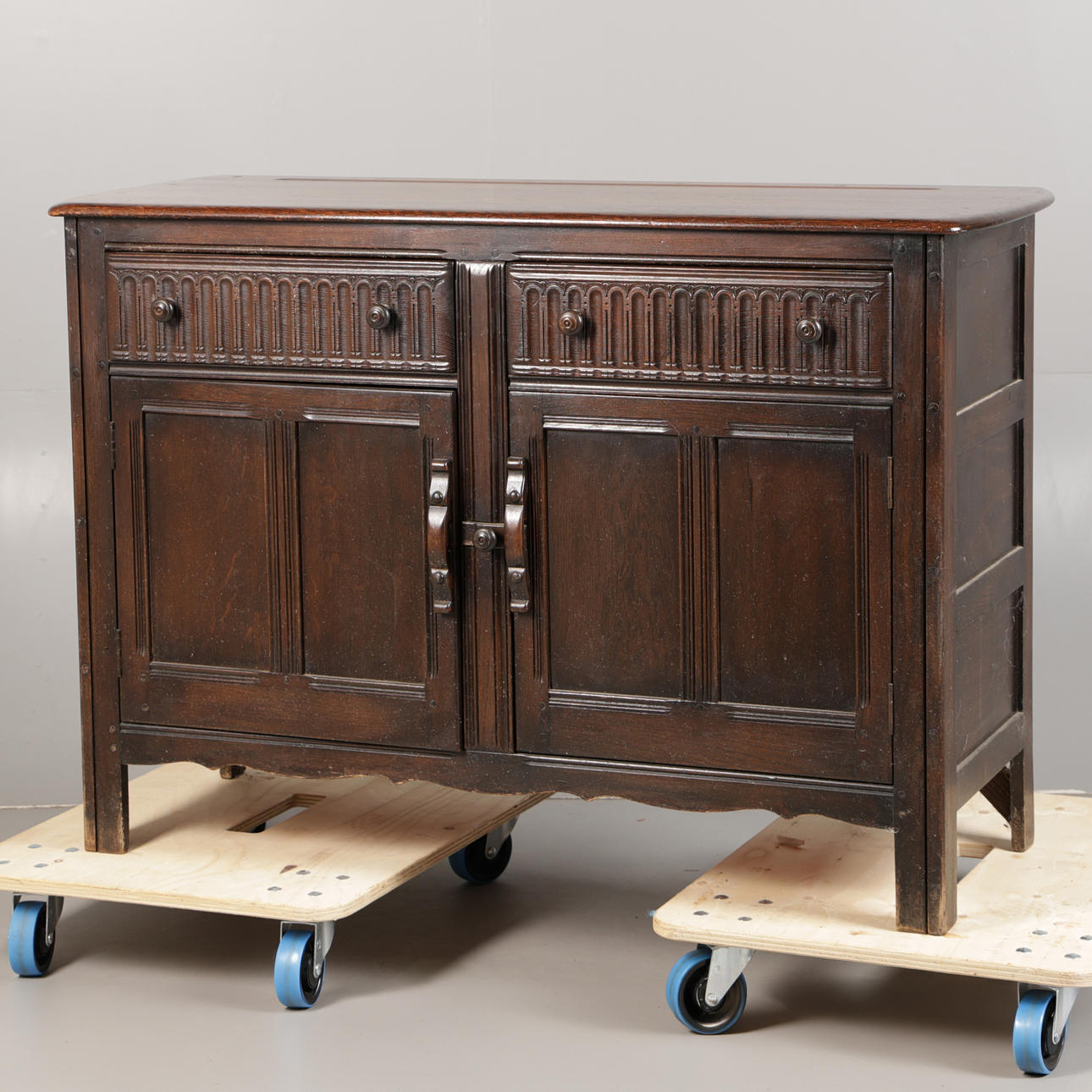 AN ERCOL ELM SIDEBOARD.