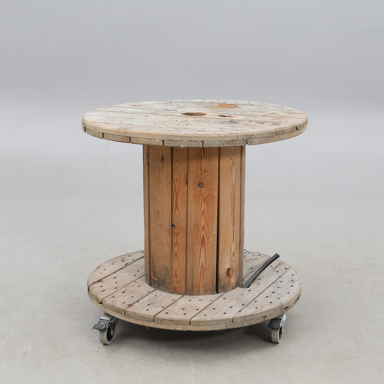 TABLE, homemade from cable drum on wheels.