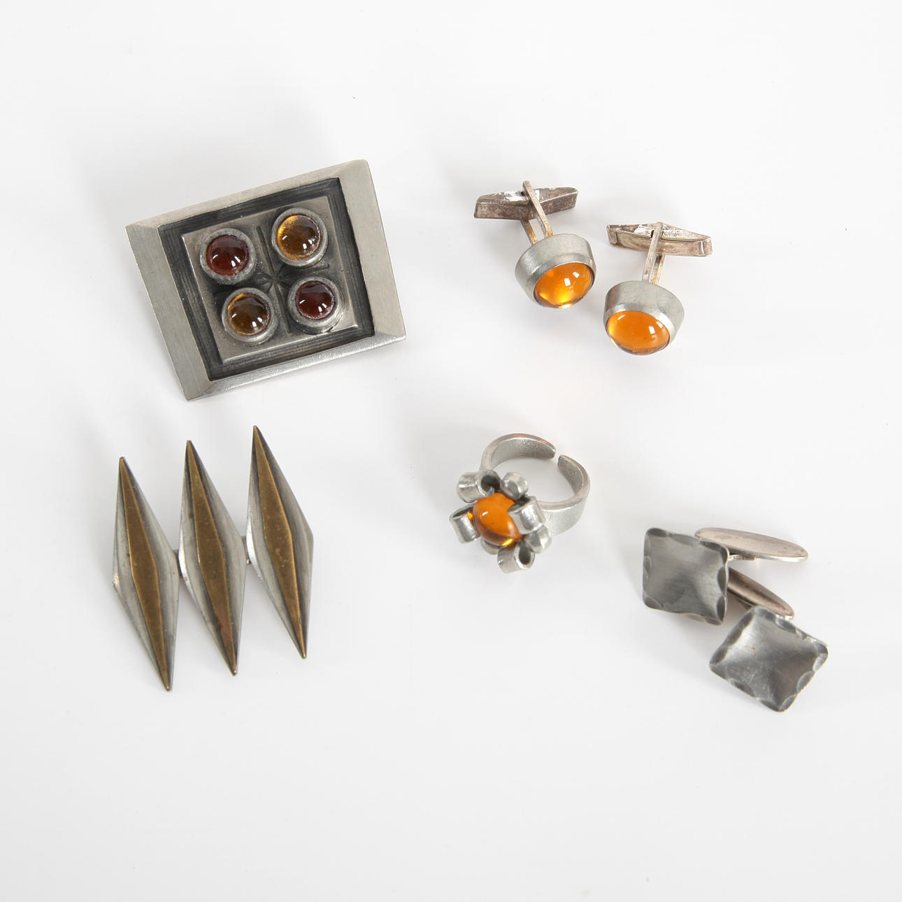 BROOCHES, CUFFLINKS AND RING, pewter and amber.
