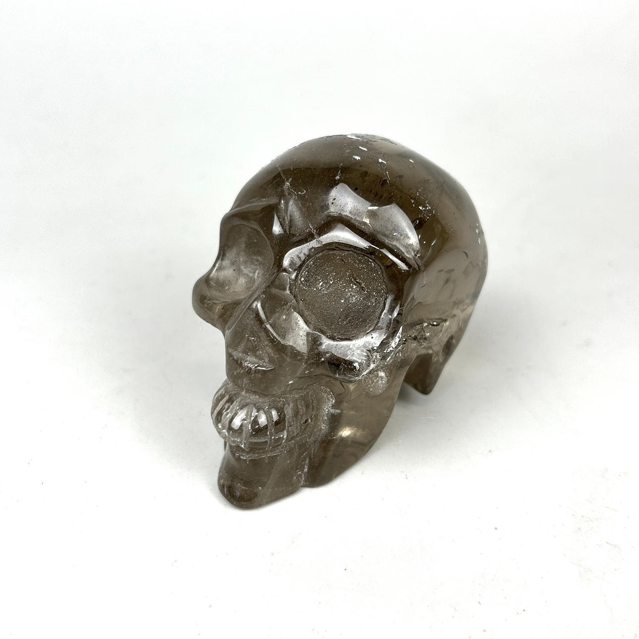 A CARVED ROCK CRYSTAL SKULL.