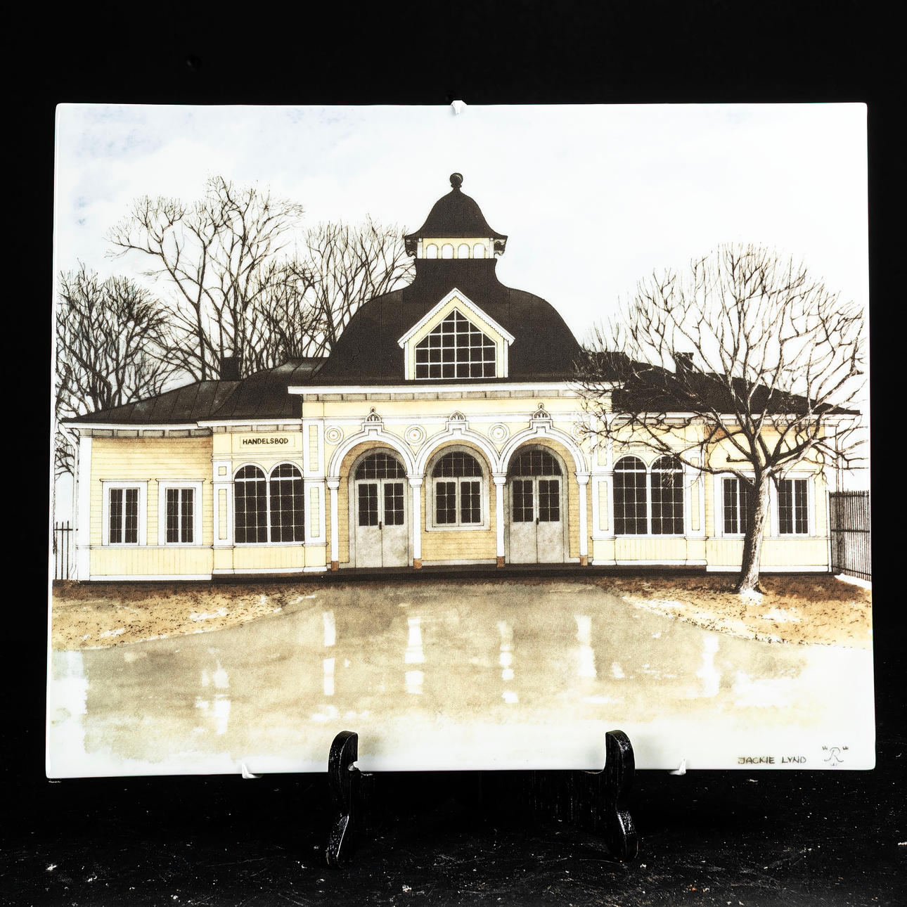 JACKIE LYND. Wall plaque, “Handelsboden”, Rörstrand, signed.
