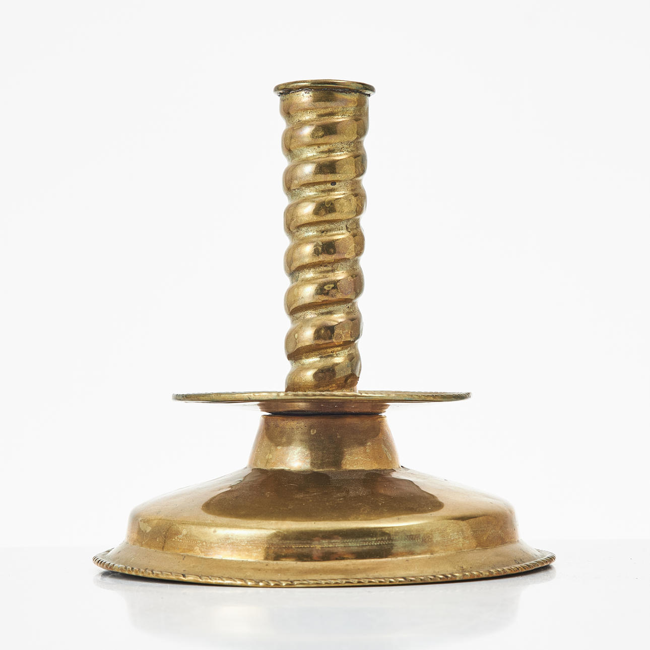 A 18th/19th century baroque candlestick, brass.
