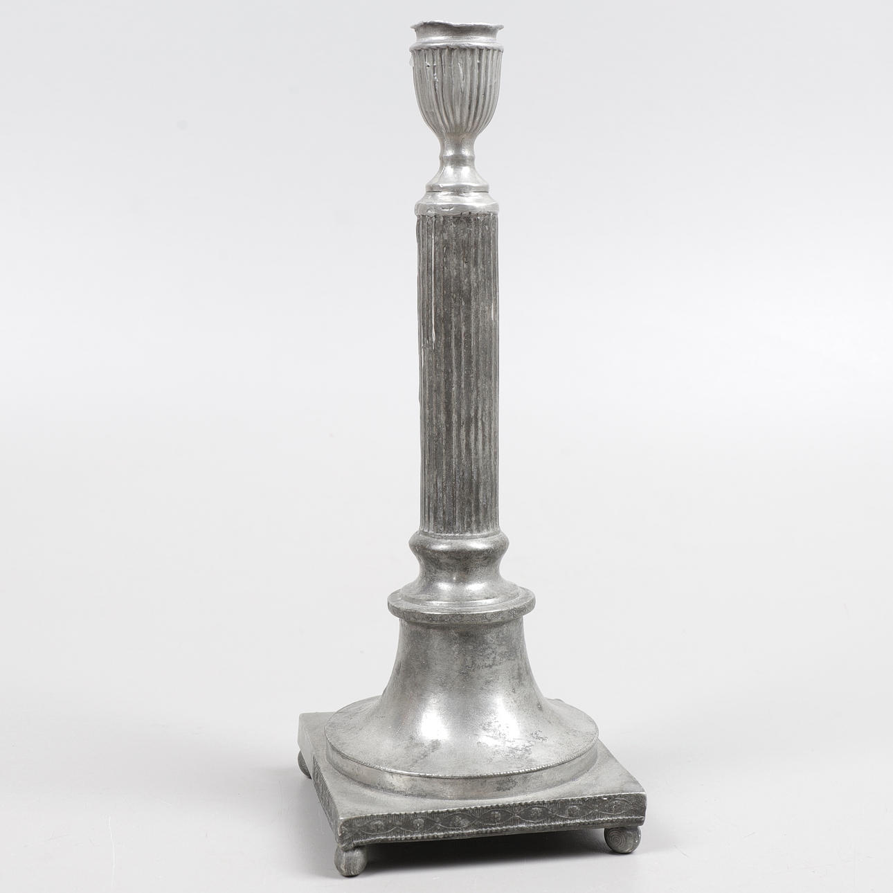 An empire pewter candlestick, 19th century.