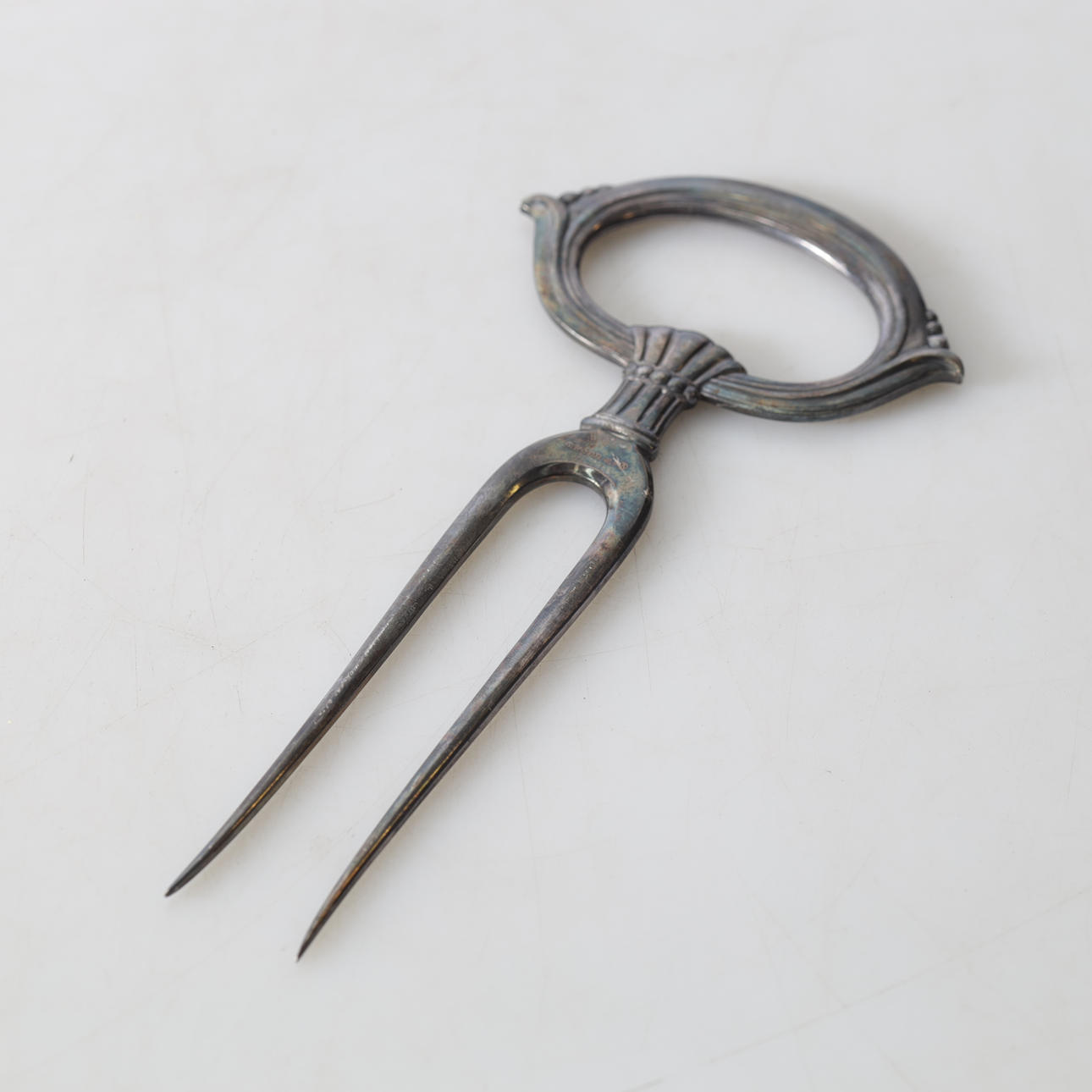 A ham fork, nickel silver, 20th century.