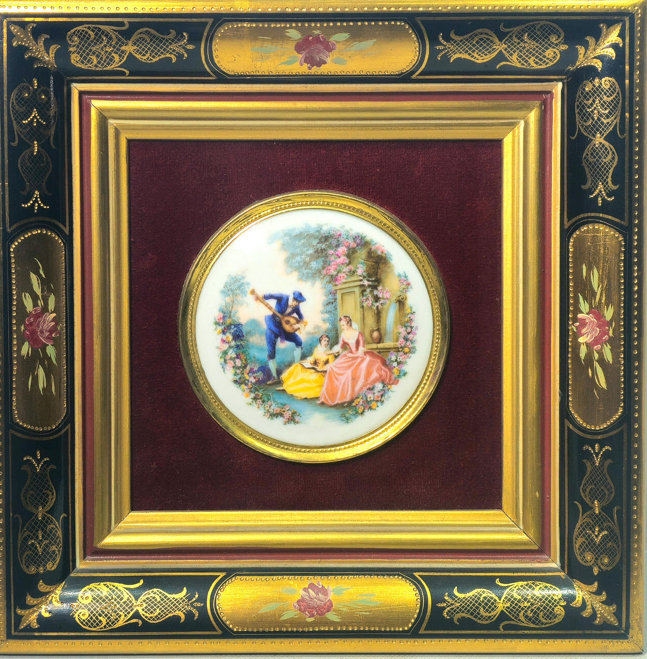 Porcelain medallion with framed bucolic scene.