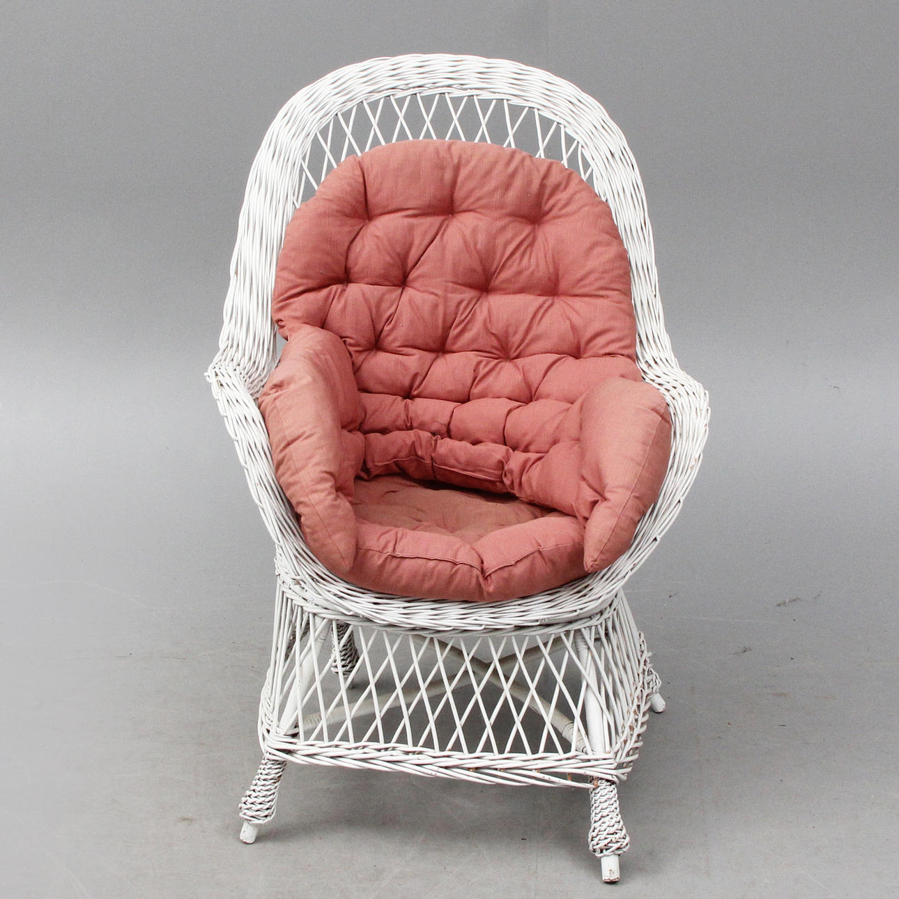 WICKER ARMCHAIR, with cushions.