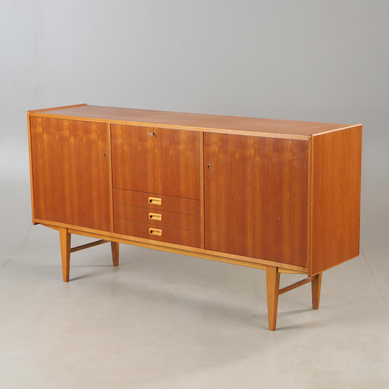 A mid 20th century teak and oak sideboard.