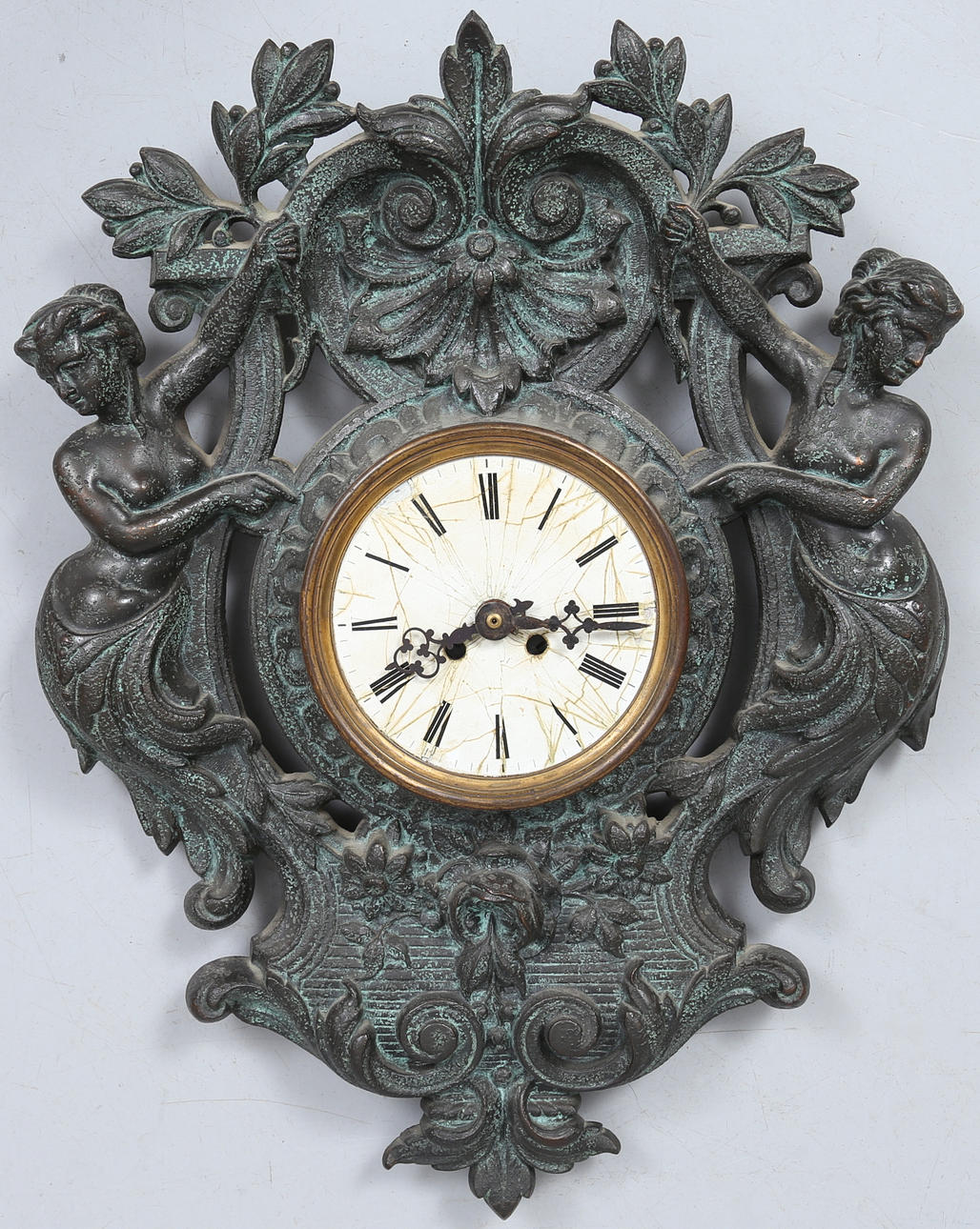 A patinated metal wall clock, contemporary.