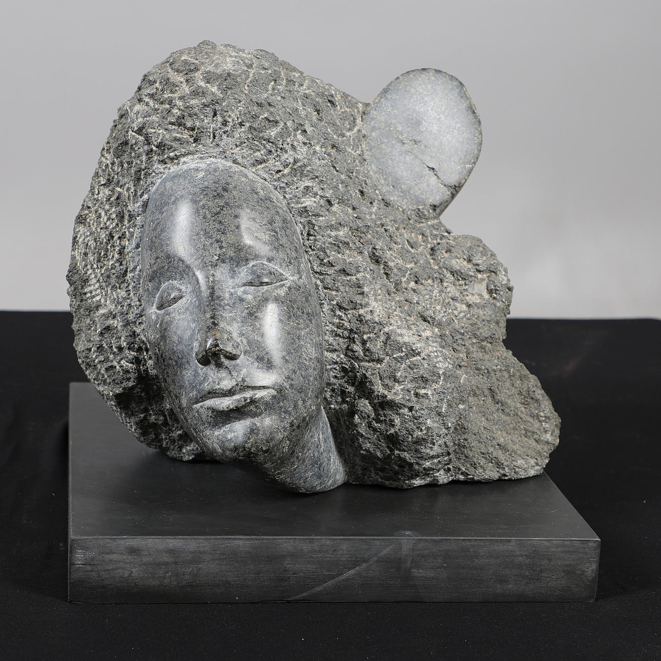 BRIDGET MCCRUM (B 1934). CARVED SCULPTURE 'LADY WITH HAIR'.