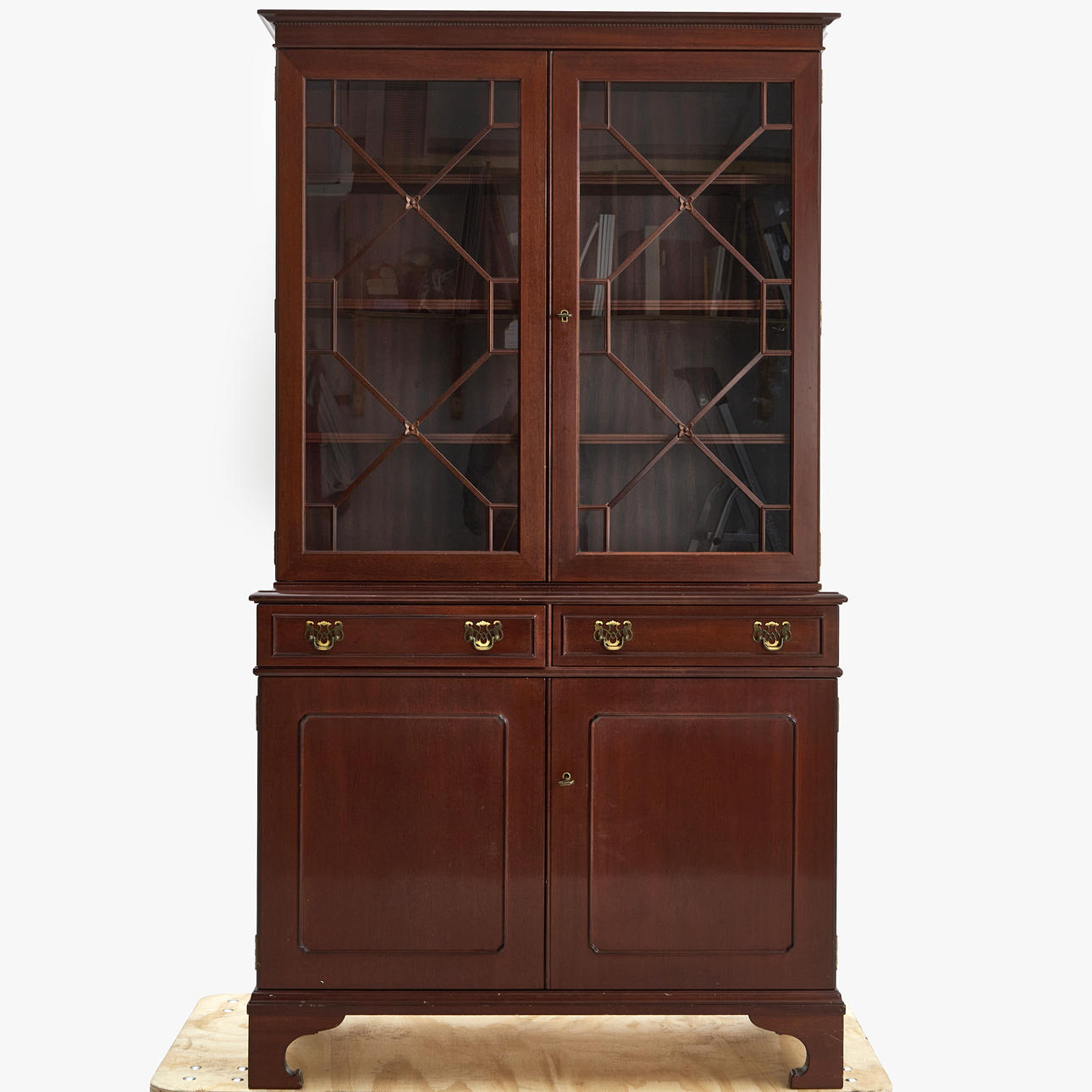 An English style bookcase, mahogany veneer, broken glass, second ...