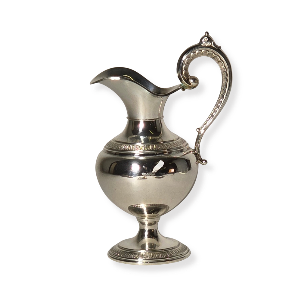 COMMUNION JUG IN PUNCHED SILVER.